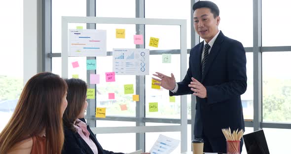 Group of business people meeting in conference room. Asian businessman speech