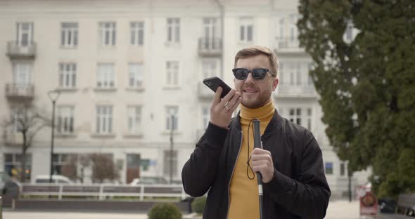 Blind Man Walking Alone in the City