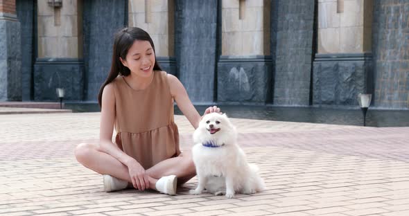 Woman playing with her dog at outdoor