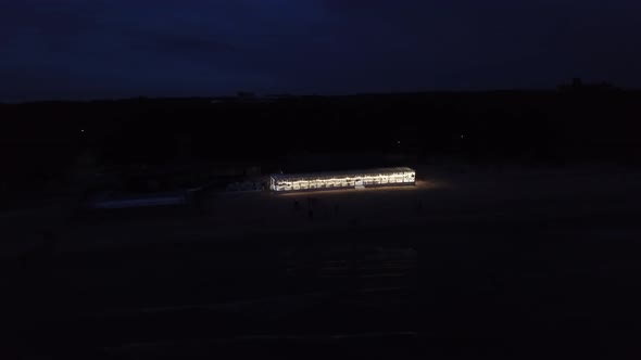 Restaurant on Beach Near Sea at Night Aerial