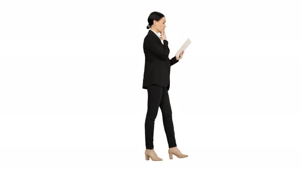 Businesswoman Using a Tablet Pad While Walking on White Background