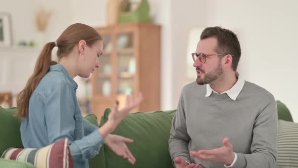 Couple Sitting on Sofa and Arguing Fighting