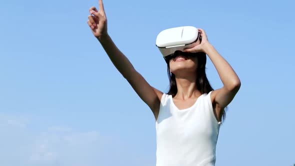 Slow motion of woman watching with virtual reality device 