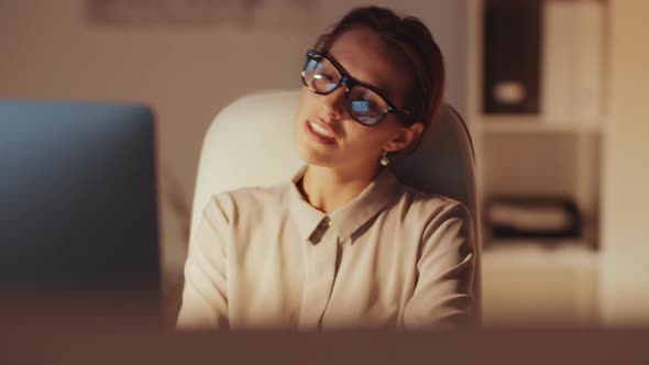 Pretty Businesswoman Chatting on Web Call in the Evening