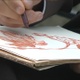 Sitting On Knees Hand Draws On Canvas Paper - VideoHive Item for Sale
