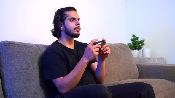 Indian gamer playing video games late at night