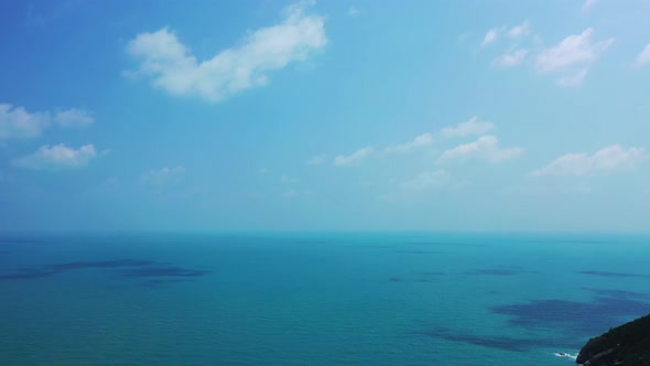 Tropical birds eye copy space shot of a white sandy paradise beach and aqua blue water background in