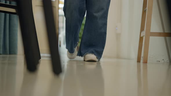 Slowmotion Woman's Legs in White Snickers and Jeans Walking Towards the Camera Lens