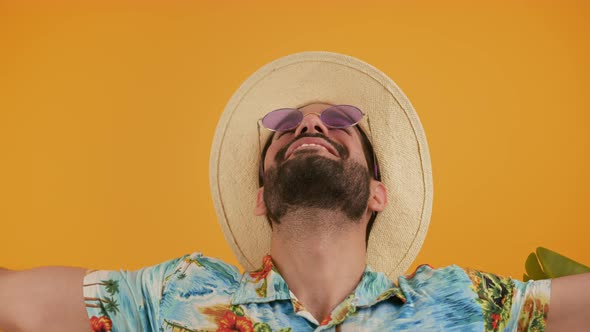 Closeup Portrain of Young Male Person Wearing Modern Sunglasses and Summer Clothes Over Orange