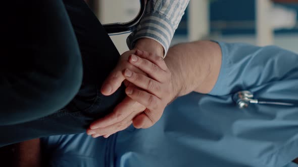 Vertical Video Close Up of Hands of Man Nurse Comforting Senior Patient