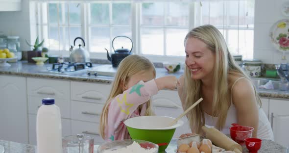 Mother and daughter making christmas cookies at home 4k