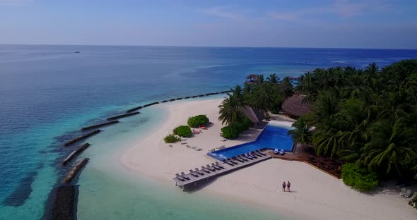 Daytime overhead abstract view of a white sandy paradise beach and aqua blue water background in hig