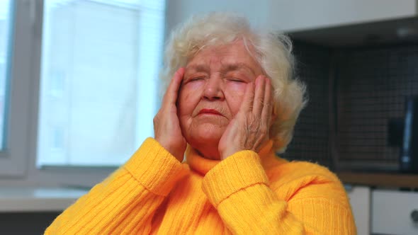 Headshot of Aged Woman Feeling Head Ache at Home