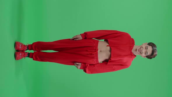 Full Body Of Young Asian Transgender Male Warmly Smiling On Green Screen Background In The Studio