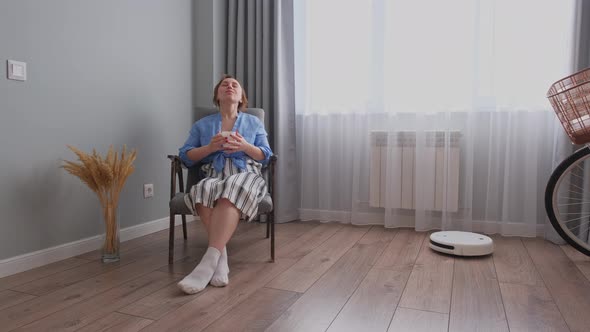 The Girl Turned on the Robot Vacuum Cleaner to Clean the Room