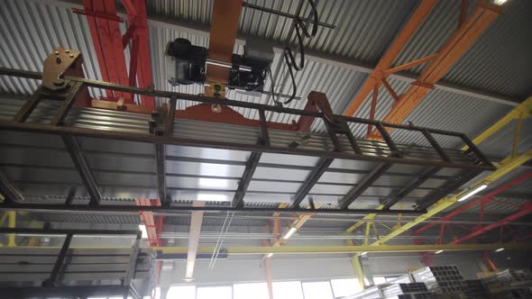 Crane Beam Moves Stack of Aluminum Profiles in a Factory Warehouse. Heavy Metallurgical Industrial