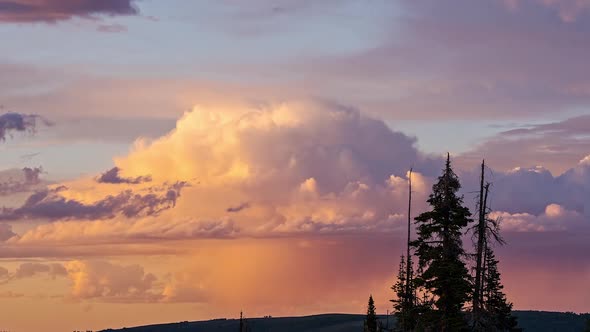 Time lapse of storm clouds building during colorful sunset