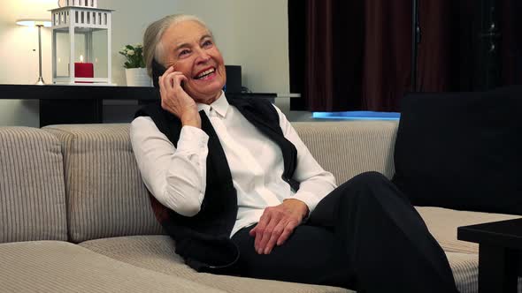 Old Happy Caucasian Woman Phone in Living Room and Smile