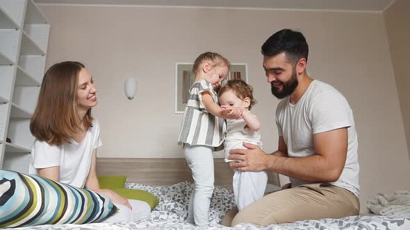 Mother, Father and Their Adorable Kids Playing Together.