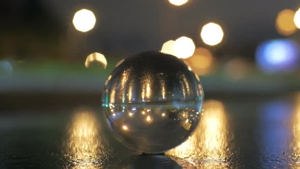 View of glass sphere imaging inverted cityscape with road