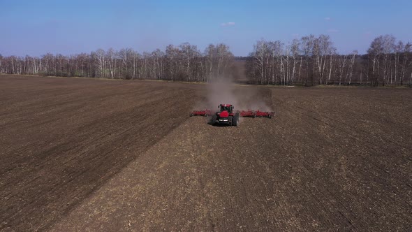Farmer in Tractor Preparing Land with Seedbed Cultivator Aerial View