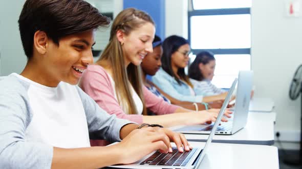 Students using laptop in classroom