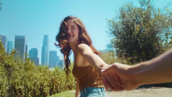 Happy Woman Holding Boyfriends Hand Going at Park