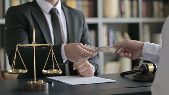 Close Up Shoot of Lawyer Hand Receiving Money in Court Room