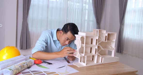 Male Architect Hands Making Model House