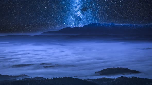 Milky way over flowing clouds in the Tatra Mountains at night, Poland, timelapse, 4K