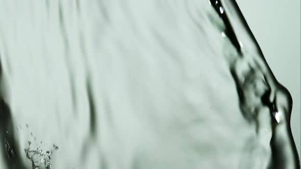 Water pouring and splashing in ultra slow motion 1500fps on a reflective surface - WATER POURS alt