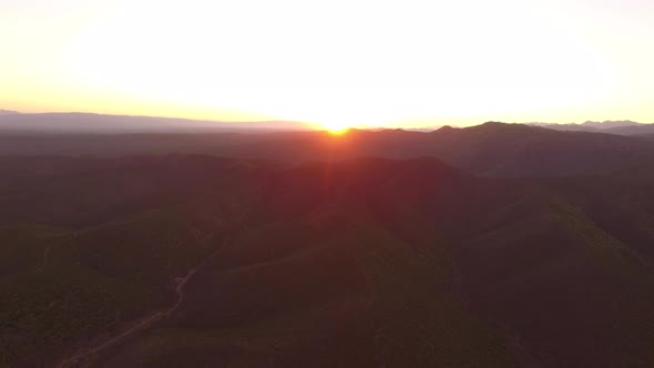 Aerial travel drone view of the sunset in Oudtshoorn, Western Cape, South Africa.