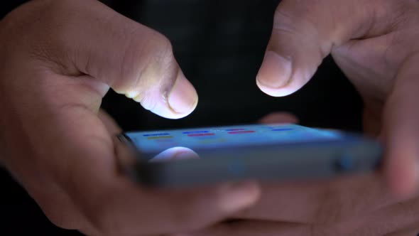 Close Up of Man's Hand Using Smart Phone at Night