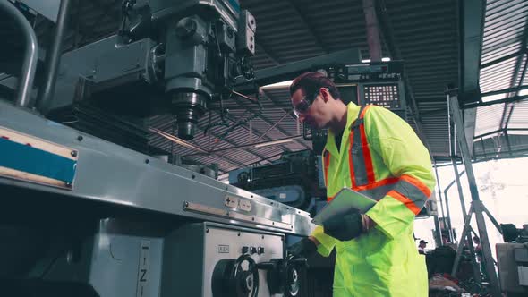 Smart Factory Worker Using Machine in Factory Workshop