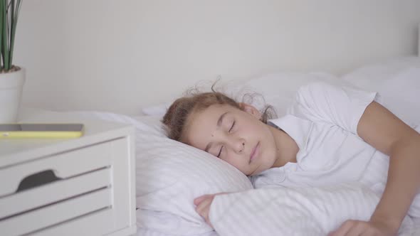 Cute Little Girl Sleeping in the Bed at Home