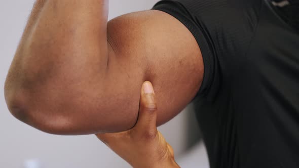 Woman's Hand Touching Sportsman Biceps Close Up