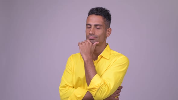 Young Handsome Persian Businessman with Yellow Shirt Thinking