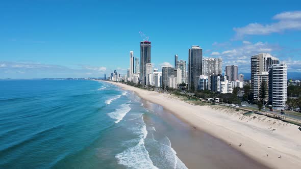 Modern architectural skyline rising above the ocean on a coastal stretch of surf beach at a popular