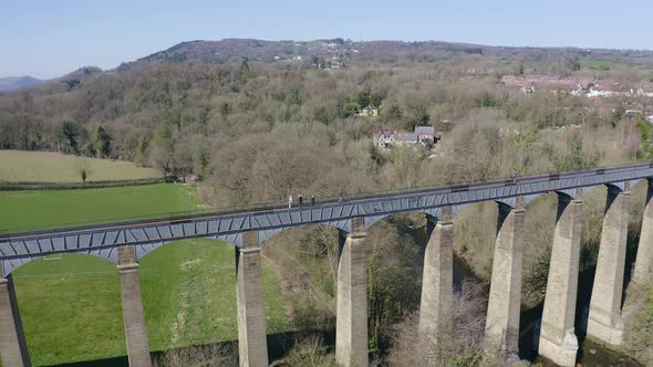 People walk across the beautiful  Narrow Boat canal route called the Pontcysyllte Aqueduct famously