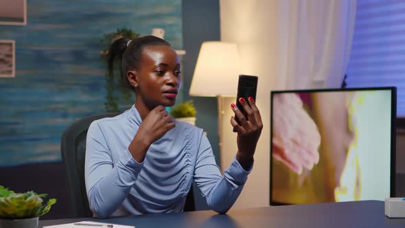 African Lady Having Virtual Meeting Using Phone