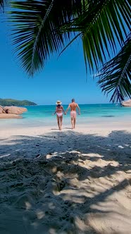 Anse Source d'Argent La Digue Seychelles Young Couple Men and Woman on a Tropical Beach During a