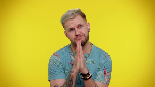 Trendy Young Adult Man Praying Looking Upward and Making Wish Asking God for Help Begging Apology