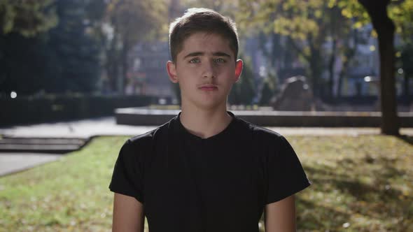 Young Man Smiling and Looking at Camera. Portrait of a Happy Handsome Young Man in a Urban Street