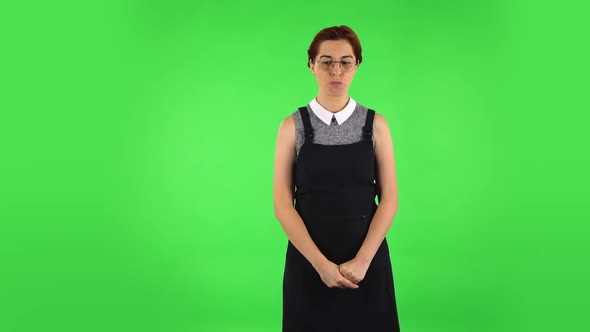 Funny Girl in Round Glasses Is Waiting and Angry. Green Screen