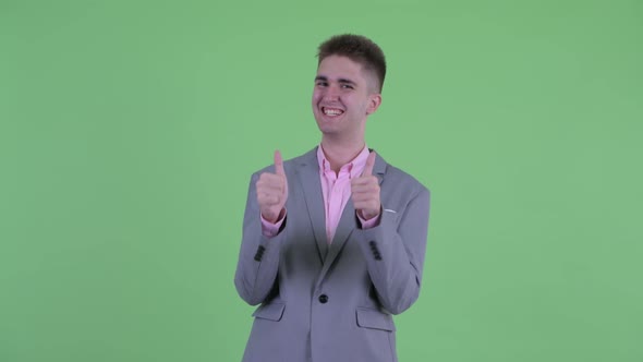 Happy Young Businessman Giving Thumbs Up and Looking Excited