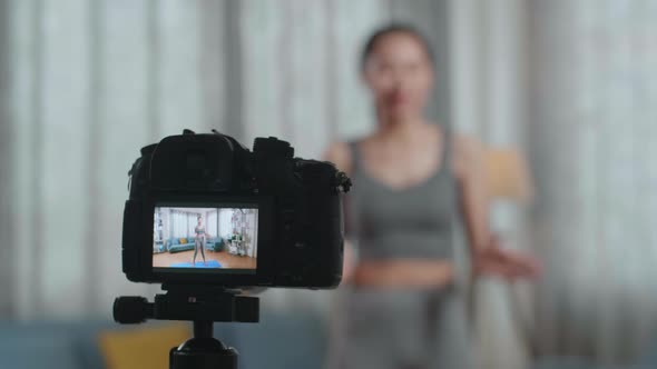 Camera Monitor Recording Asian Trainer Female Waving Hand  And Speaking While Teaching Exercise