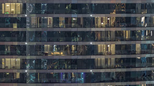 Outside View of Windows in Apartments of a High Class Building at Night Timelapse