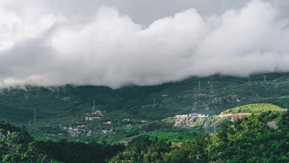 Timelapse Green Mountains and Thick Clouds of Little Houses in the Mountains