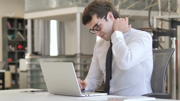 Tired Businessman with Neck Pain at Work