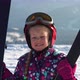 Little Girl Wearing Red Helmet and Outwear Holding Mountain Skis in Sunlight - VideoHive Item for Sale